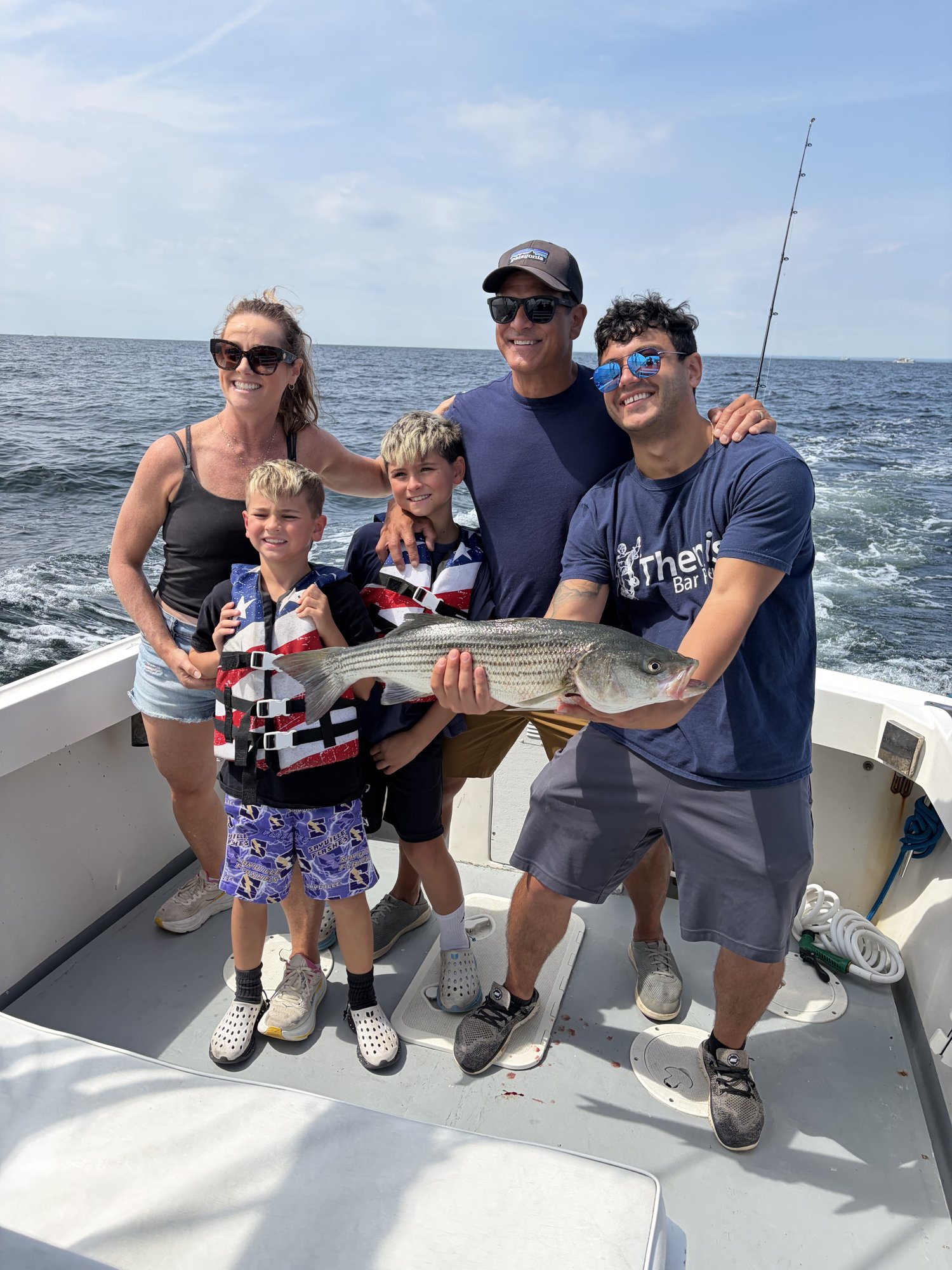 Family of four with a striped bass underway on the Christina M II on the Long Island Sound